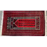 An Afghan Khal Mohammadi woollen rug, woven with geometrical bands, in deep red, brown and black,