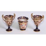A pair of Royal Crown Derby 2451 pattern two-handled pedestal vases, 11cm high; printed marks;