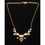 A Victorian style 15ct gold and seed pearl necklace, the articulated sections formed as flowering