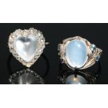 A diamond and moonstone heart cluster ring, cental moonstone heart cabochon, surrounded by