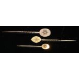 A 19th century diamond and seed pearl yellow metal stick pin, as a flower, unmarked; another navette