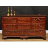 A George III mahogany Lancashire chest, hinged top above an arrangement of drawers, the upper