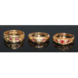 An 18ct gold ring, set with three rubies divided by four small diamonds, engraved with scrolls to