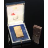 A Dunhill 70 cigarette lighter, FY835, textured gold coloured body, flick lid, roll striker, boxed