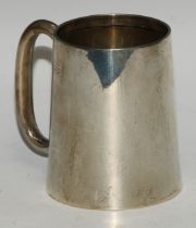 A George V silver spreading cylindrical mug, quite plain, gilt interior, 11.5cm high, Chester