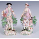 A pair of Derby patch mark figures, of a beau and his lady, pierced scroll bases, he stands 26cm