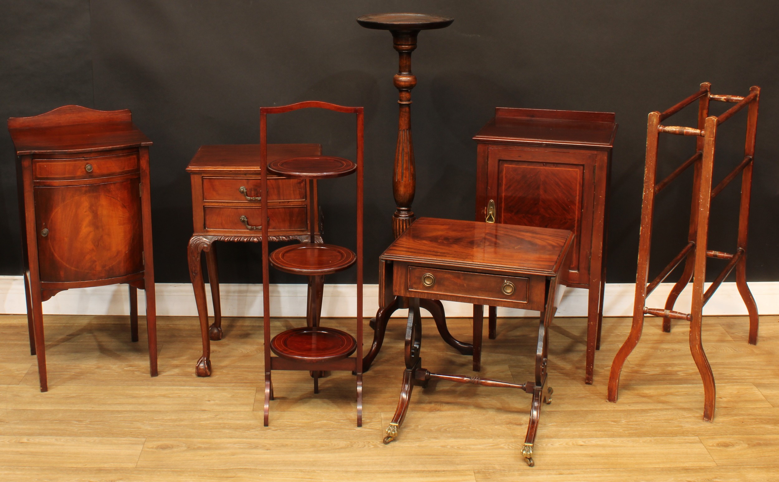 A George II style bedside or lamp table; an Edwardian bedroom cabinet; another; a folding three-tier