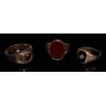 A 9ct gold carnelian signet ring, plain oval matrix, stamped 9ct gold, 4.5g gross; another garnet