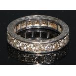 A diamond eternity ring, set with a continuous single row of brilliant cut stones, engraved white