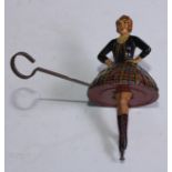 Toys & Juvenalia - a 1930's novelty tinplate spinning top toy, in the form of a Scottish dancer,