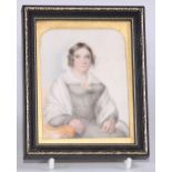 English School, 19th century, a portrait miniature, of a Victorian lady, seated with ringlets in her