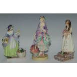 A Royal Doulton figure, Spring Flowers, 18.5cm high, HN1807; others, Phyllis and The Bridesmaid (3)