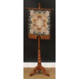 A Victorian walnut pole screen, bead and woodwork banner, spirally turned column, cabriole legs