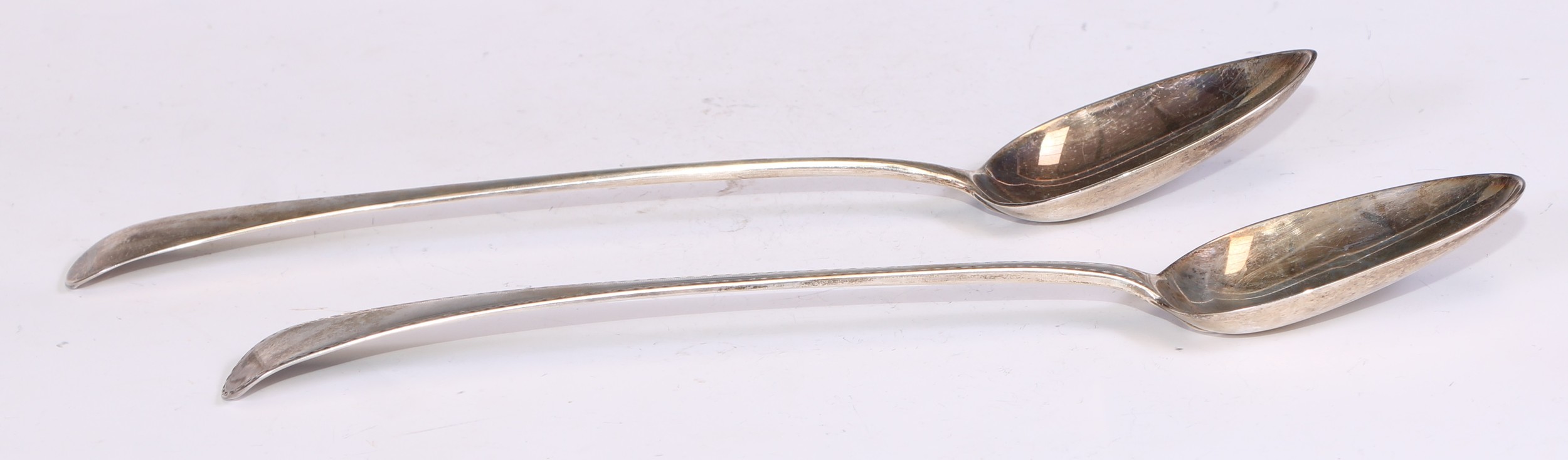 A George III silver Bright-cut Old English pattern basting spoon, 30cm long, London 1786; another,