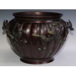 A large Japanese brown patinated bronze fluted ovoid jardiniere, cast and applied with song birds on