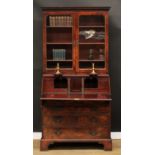 A George III mahogany bureau bookcase, dentil cornice above a pair of glazed doors enclosing