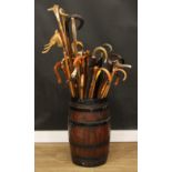 A 19th century coopered oak barrel stick stand containing a collection of 19th century and later