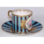 A Lynton Porcelain Company coffee can and saucer, painted by Stefan Nowacki, signed, with a spray of