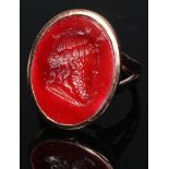 A gentleman's carnelian intaglio ring, the oval tablet engraved with a Greek philosopher, after