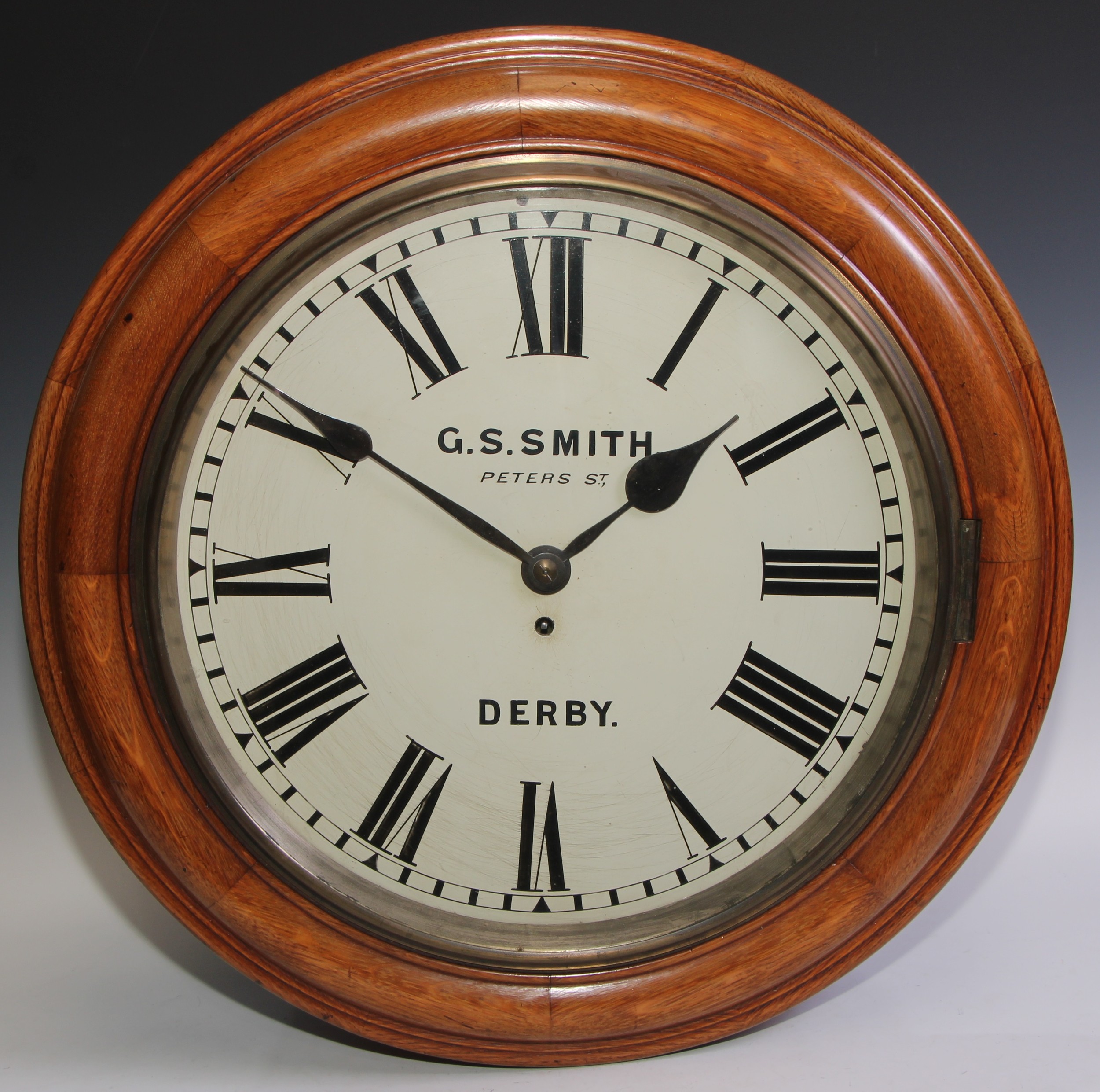 A large early 20th century oak circular wall timepiece, the 41cm painted clock dial inscribed G S