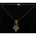 An Edwardian peridot floral ribbon bow pendant necklace, vibrant oval principle stone, twenty four