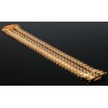 A 18ct gold articulated bracelet, formed from 32 shaped panels, 19cm long, 31g