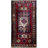 A Persian woollen rug, with geometrical motifs, banded border, 212cm long, 123cm wide
