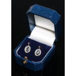 A pair of sapphire and diamond oval cluster drop earrings, the pale blue stones open set within a