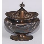 An Art Nouveau silver bombe shaped tea caddy, embossed with stylised flowers on whiplash stems,