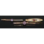 A 9ct gold and amethyst bar brooch, the central oval faceted stone flanked by seed pearls, 5.5cm