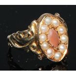 A 19th century seed pearl and hardstone navette shaped ring, the shoulders cast with leafy scrolls,