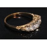 A five stone diamond ring, the graduated stones within a scroll mount, 18ct yellow gold shank,