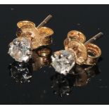 A pair of diamond solitaire ear studs, round old brilliant cut diamonds, claw set, unmarked yellow
