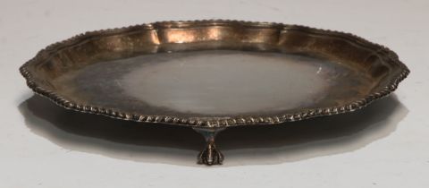 A George III style silver shaped circular waiter, plain field, ball and claw feet, 20.5cm diam,