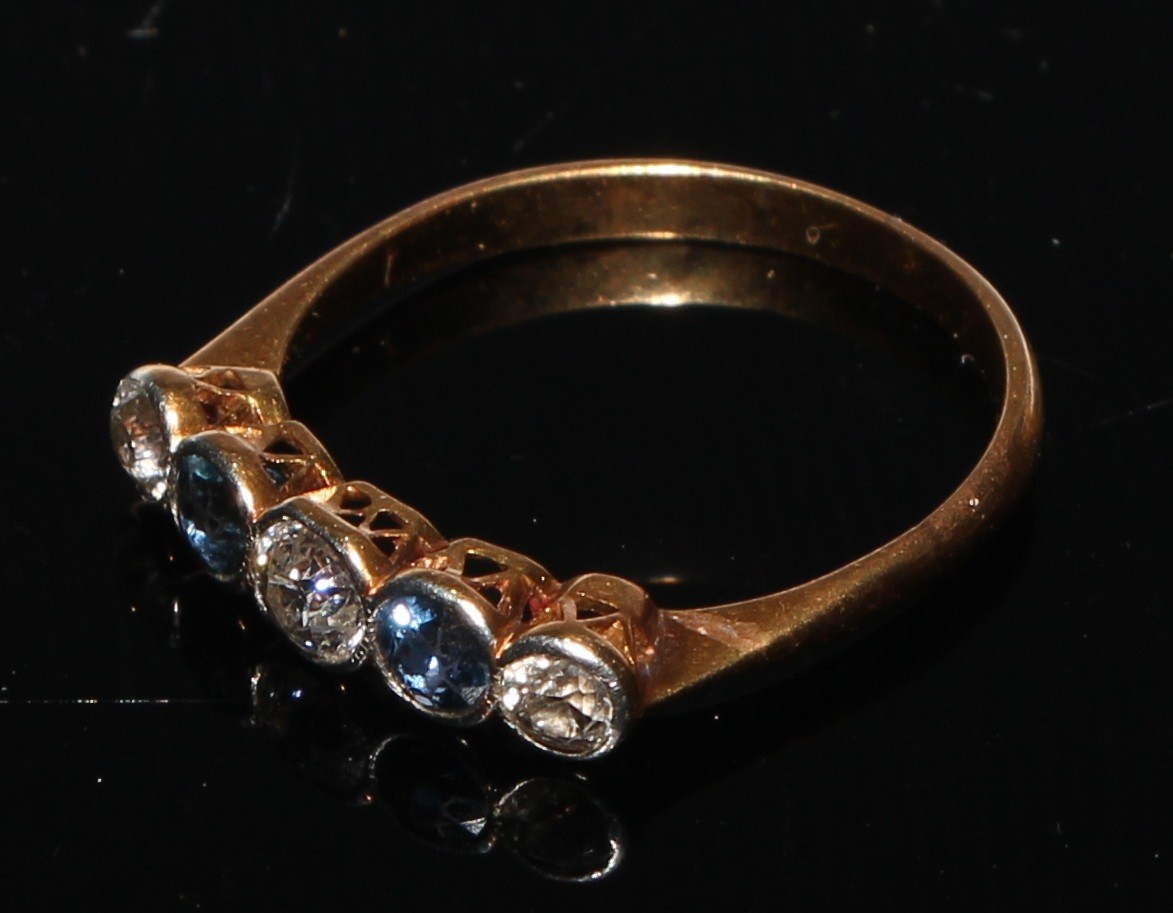 A five stone diamond and sapphire ring, the three diamonds divided by two sapphires, gold coloured - Image 2 of 2