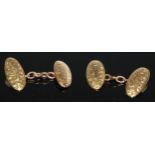 A pair of 18ct gold elongated oval cufflinks, engraved and chased with foliate scrolls, 7g