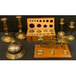 A set early 20th century postal scales and weights; a brass desk bell; a set of graduated weights,