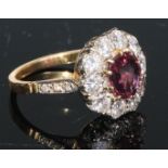 A ruby and diamond cluster, the central facet cut ruby within 11 brilliant cut stones, 18ct yellow