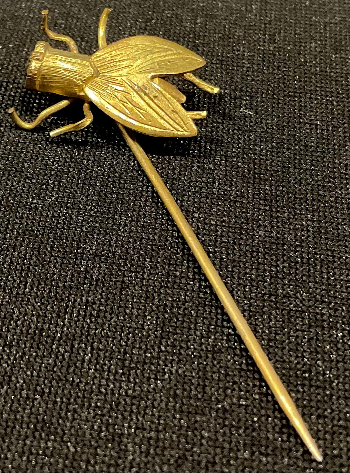 A Victorian stick pin as a gold coloured metal fly, diamond lozenge registration mark, c.1860.
