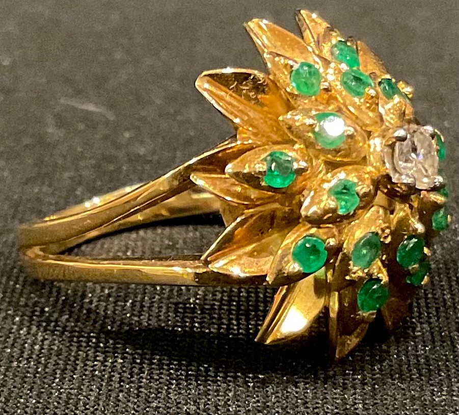 An unmarked 18ct gold diamond and emerald cluster ring, size P, 9.56g