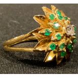 An unmarked 18ct gold diamond and emerald cluster ring, size P, 9.56g