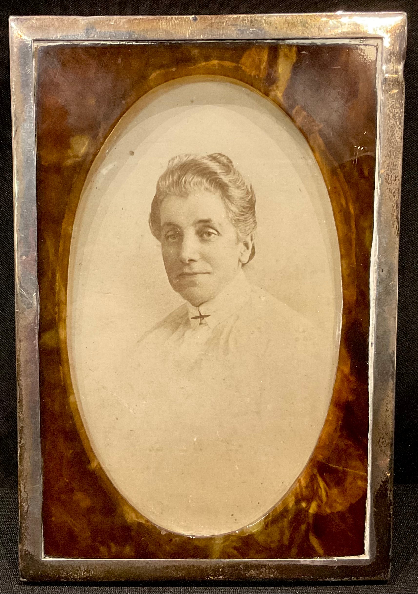 A hallmarked silver and tortoiseshell photograph frame