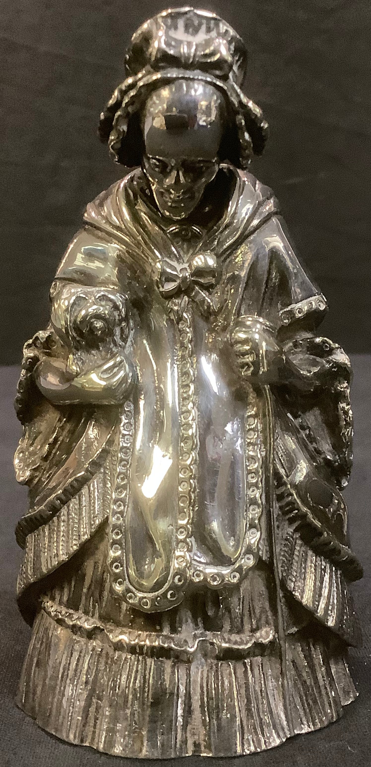 An unusual 19th century silver plated figural table bell, cast as a lady with a nodding head, 11cm - Image 2 of 2