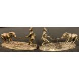 A pair of silver plated knife rests, each as a man with a stubborn donkey, 10cm long