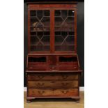 A George III mahogany bureau bookcase, moulded cornice above a pair of doors enclosing a shelf, fall