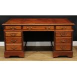 An early 20th century mahogany twin pedestal desk, rectangular top with inset tooled and gilt