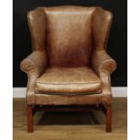 A George III style reception wingback armchair, stuffed-over upholstery with studded border, squab