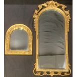 An ornate bevelled glass mirror, ornate arch top; another, arch topped, largest 37x82cm