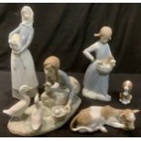 A Lladro figure, goose Girl, 23cm wide; other Lladro figures, girl with lamb, 27.5cm; Calf and