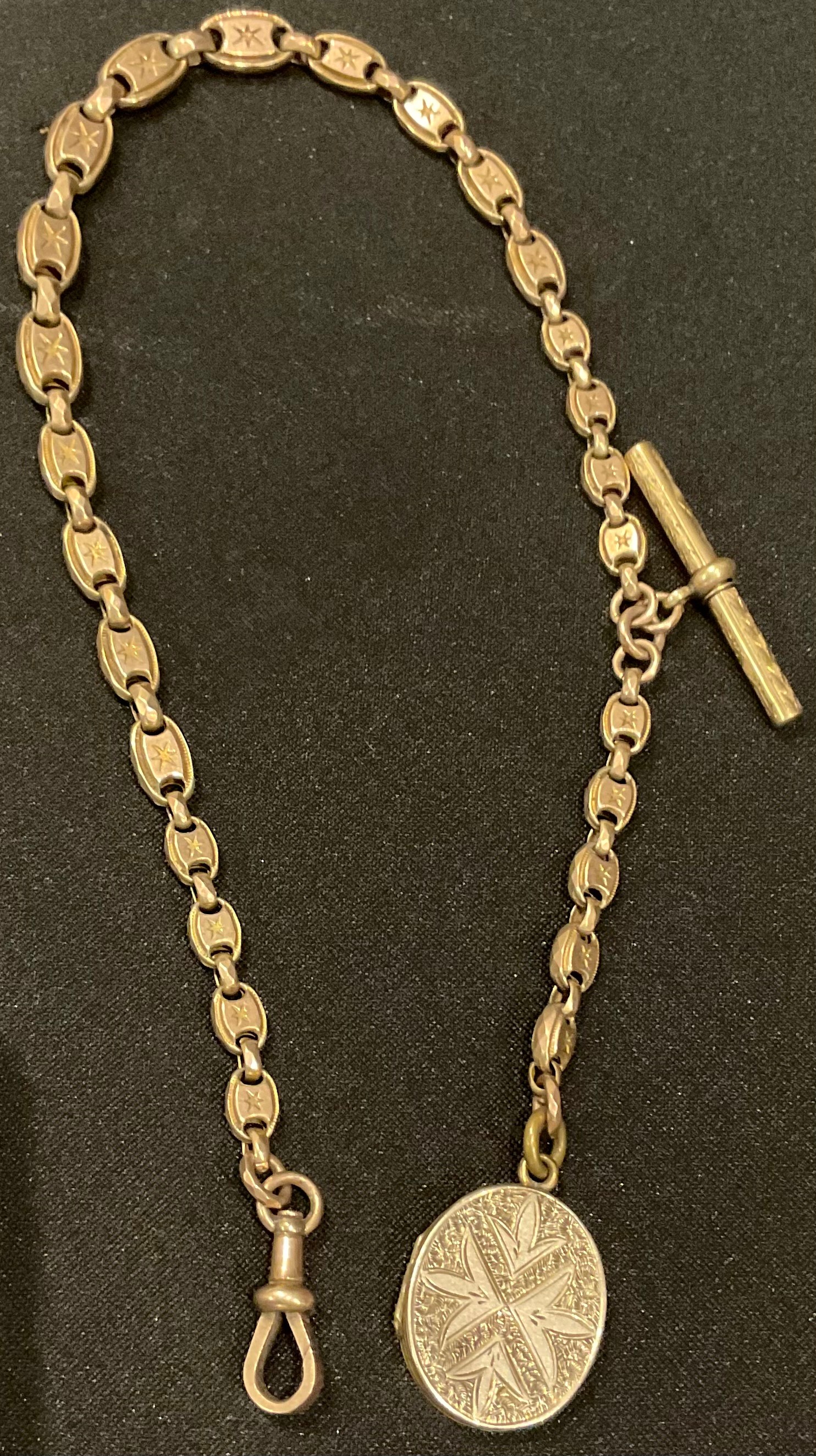 A Victorian 9ct gold graduated fancy link Albert chain, brass T-bar, gold plated locket, marked 9ct,